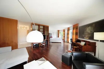 a living room with a couch and a table at Villa Tivoli in Merano
