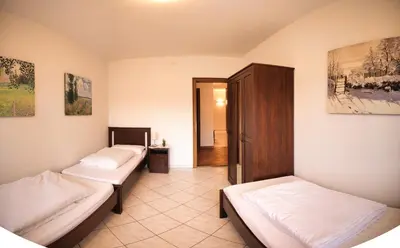 a room with two beds and a hallway at Holiday Home Falzes in Falzes