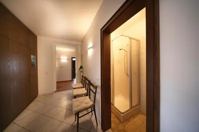 a hallway with a row of chairs and a shower at Holiday Home Falzes in Falzes