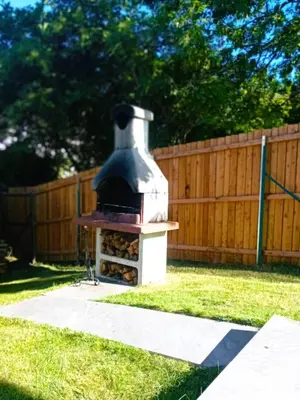 a fireplace in a yard next to a wooden fence at Holiday Home Falzes in Falzes