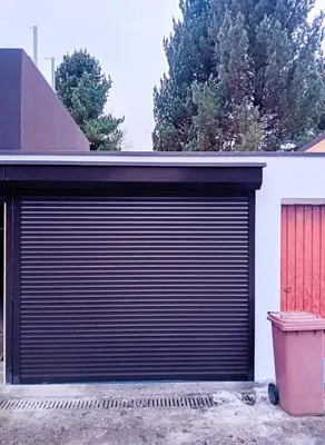 a garage door with a trash can next to a building at Holiday Home Falzes in Falzes