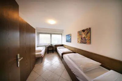a room with two beds and a table in it at Holiday Home Falzes in Falzes