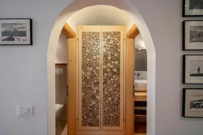 a room with a door with a bunch of logs at Casa Gialla in Varena