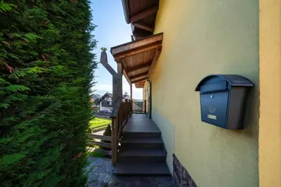 a stairway with a trash can on the side of a building at Casa Gialla in Varena