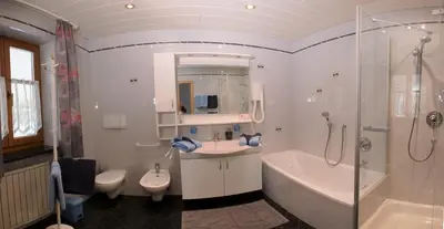 a bathroom with a sink and a toilet and a shower at Residence Prunarhof in Caldaro