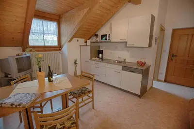a kitchen with a table and a dining room at Residence Prunarhof in Caldaro