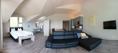 a living room with a couch and a bed at Residence Prunarhof in Caldaro
