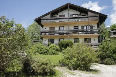 a house with a fence next to a dirt road at CASA 4 PIOPPI - 2 camere, balcone, garage Dolomiti Affitti in Cavalese