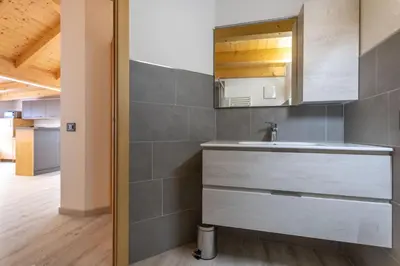 a kitchen with a sink and a mirror at Chalet Butterfly 3 in Mazzin
