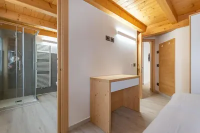 a room with a bed and a glass shower at Chalet Butterfly 3 in Mazzin