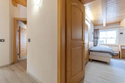 a small bedroom with a bed and a window at Chalet Butterfly 3 in Mazzin