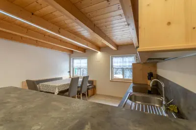 a kitchen and dining room with a table and chairs at Chalet Butterfly 3 in Mazzin