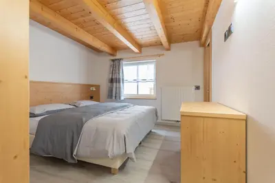a bedroom with two beds and a window at Chalet Butterfly 3 in Mazzin