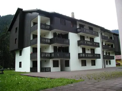 an apartment building with balconies on the side of it at Des Alpes 3 in Canazei