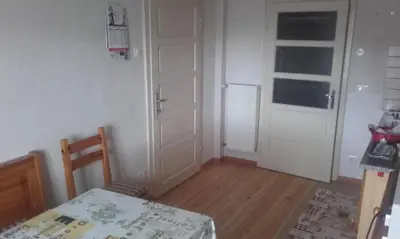 a small room with a table and a white door at B&B Signora Elvira in Capriana