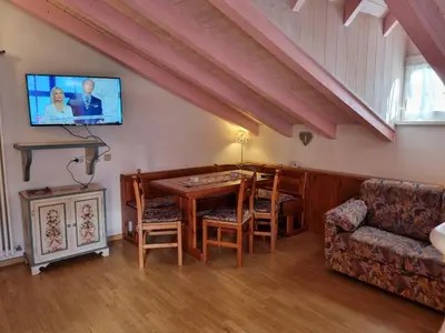 a living room with a table and a couch and a tv at Cesa Alegra in Campestrin