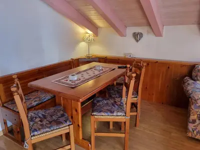 a dining room with a wooden table and chairs at Cesa Alegra in Campestrin