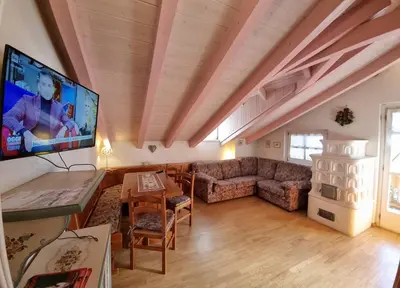 a living room with a couch and a tv at Cesa Alegra in Campestrin