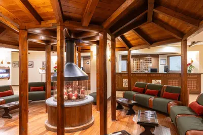 a living room with a couch and a window at Hotel Alaska Cortina in Cortina dʼAmpezzo