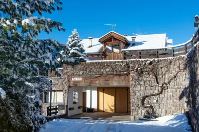 a house in the winter with snow on the ground at Apartment Villa Hetty in Ortisei