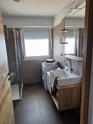 a bathroom with a sink and a shower at FeelHome Bruneck in Brunico