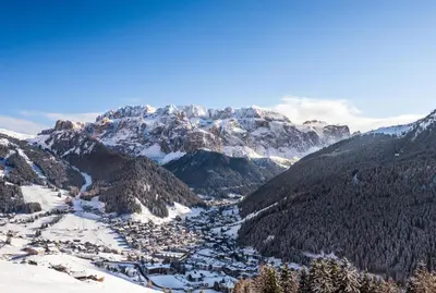 a valley in the mountains with snow covered mountains at Apartments UDERA in Selva di Val Gardena