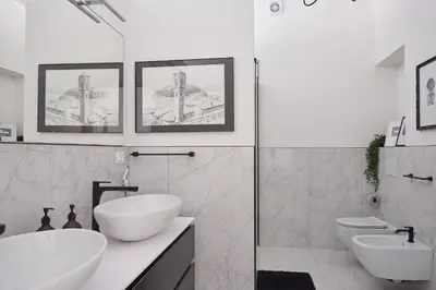 a white bathroom with two sinks and a shower at Duomo 55 MQ new flat in the centre of Bolzano in Bolzano