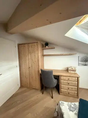 a room with a desk and a chair and a cabinet at Crystal House in Cavalese