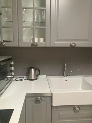 a kitchen with white cabinets and a sink at Crystal House in Cavalese