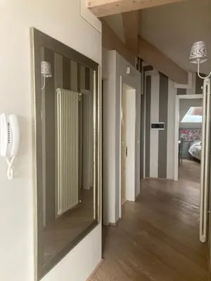 a mirror hanging on a wall in a hallway at Crystal House in Cavalese
