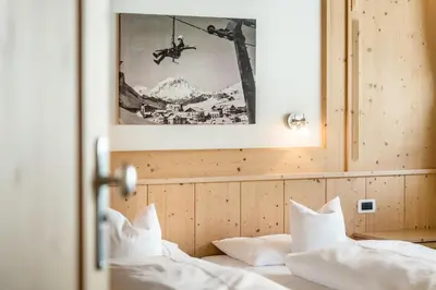 a large bedroom with a large bed and a desk at B&B - Ciasa Rü Blanch in San Cassiano