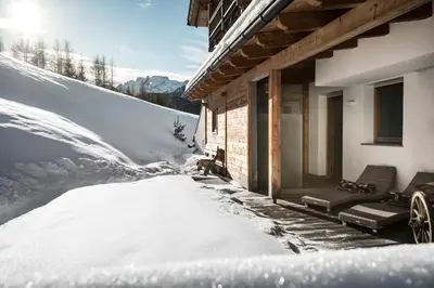 a salon with four chairs in a room at B&B - Ciasa Rü Blanch in San Cassiano