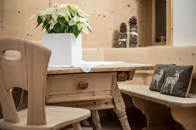 a snow covered porch of a house with a pile of snow at B&B - Ciasa Rü Blanch in San Cassiano