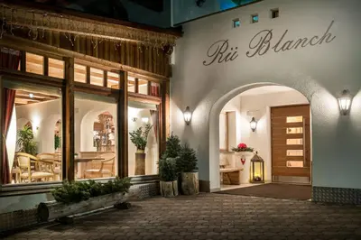 two beds in a room with a balcony at B&B - Ciasa Rü Blanch in San Cassiano