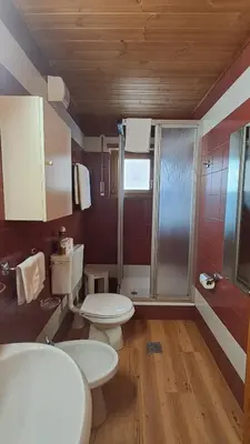 a bathroom with two toilets and a shower at Apartments Antares in Colfosco