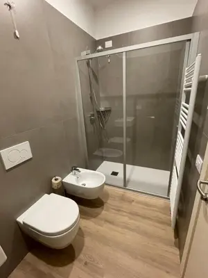 a bathroom with a shower and a toilet and a sink at Al Palazzo in Cles