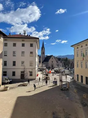 a group of people walking around a city street at Al Palazzo in Cles