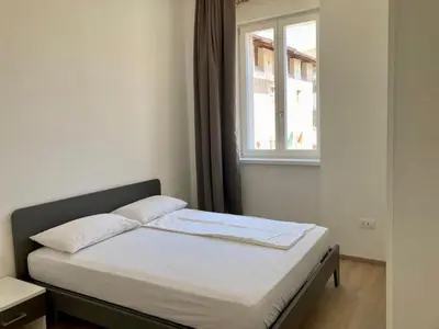 a bed in a small room with a window at Al Palazzo in Cles