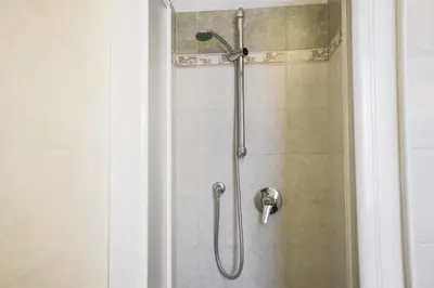 a shower in a bathroom with a glass door at Mountain Hut Veronza in Cavalese