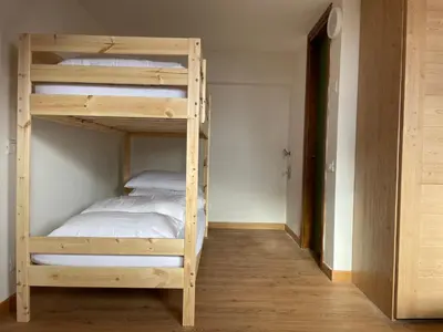 a bedroom with two bunk beds in a room at Casa Eolo Falcade in Falcade