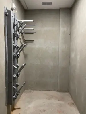 a wall with baseball racks in a room at Casa Eolo Falcade in Falcade