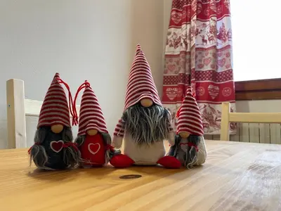 a group of three gnomes sitting on top of a table at Casa Eolo Falcade in Falcade