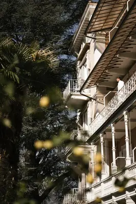 a man standing on a balcony of a building at Hotel Adria in Merano