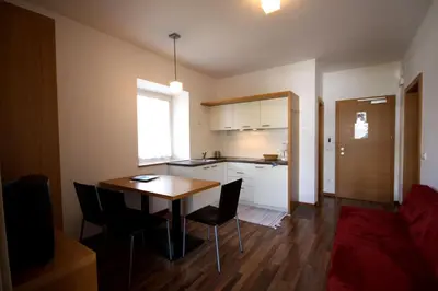 a kitchen and dining room with a table and chairs at Residence Haus Ragen in Brunico