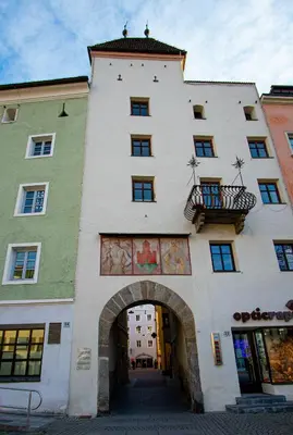 a large building with an archway in front of it at Residence Haus Ragen in Brunico