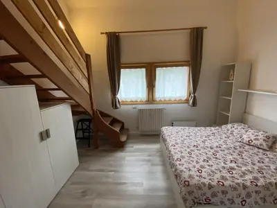 a bedroom with a bunk bed and a staircase at CASA LOLA in Falcade
