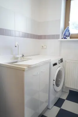 a white laundry room with a sink and a washing machine at Landhaus Anita Dolomiten Kronplatz in Perca