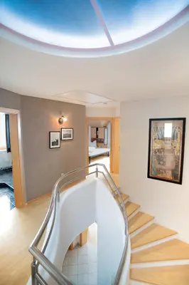 a spiral staircase in a room with a ceiling at Landhaus Anita Dolomiten Kronplatz in Perca