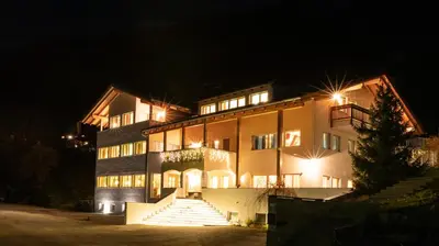 a large building with stairs leading up to it at night at Gitschberg - Appartements in Vandoies