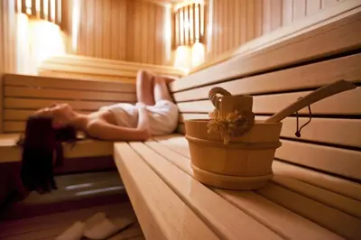 a little girl is laying in a sauna at Gitschberg - Appartements in Vandoies